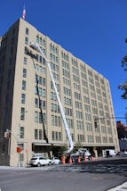 a large building with a crane in front of it