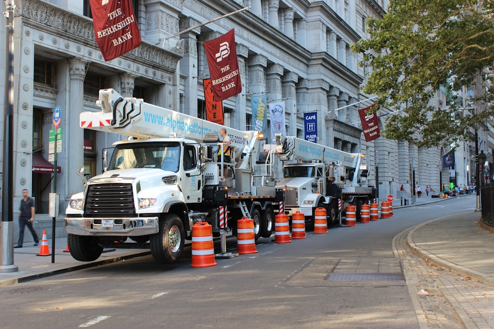 a row of utility trucks parked on the side of a street