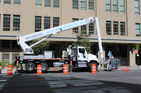 Operator safely maneuvering a boom lift on a construction site.