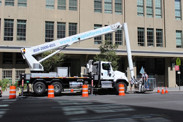 A high-quality boom lift in action at a construction site.