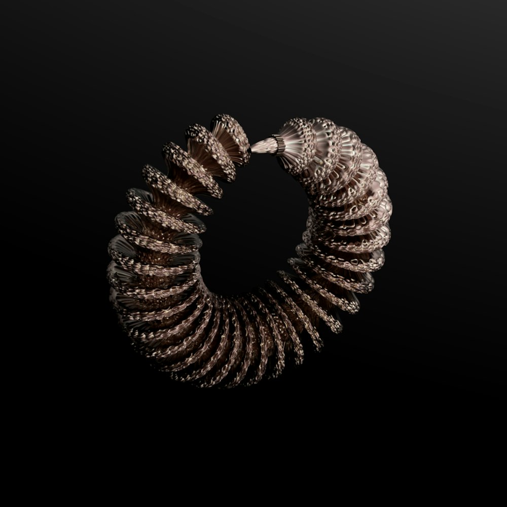 a silver spiral object on a black background