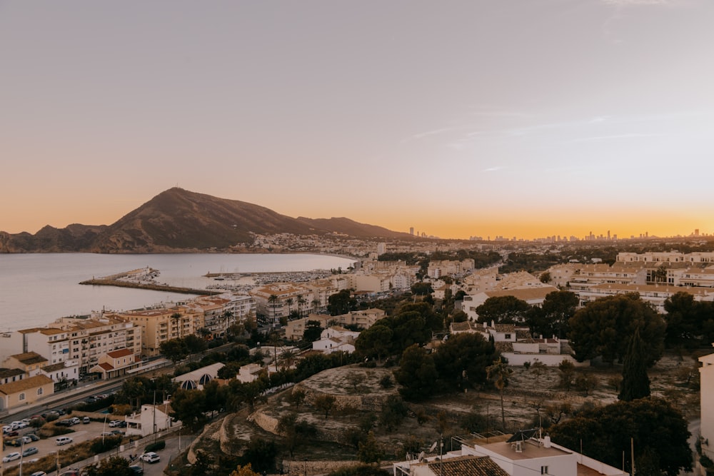 an aerial view of a city with mountains in the background