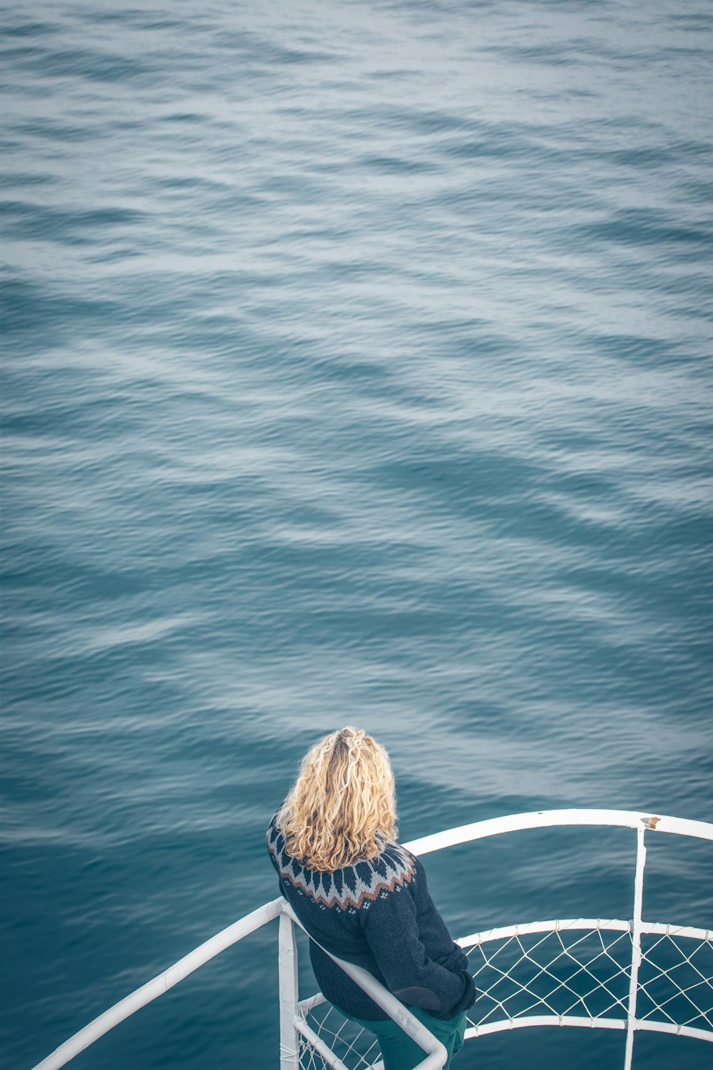 a person sitting on a boat looking out at the water