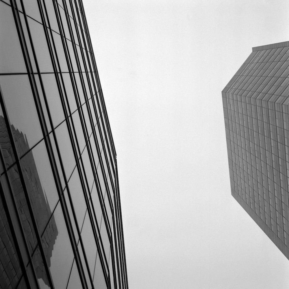 a black and white photo of two tall buildings