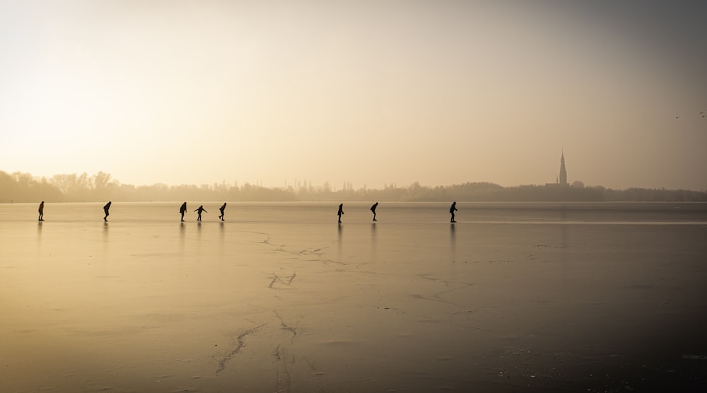 a group of people standing on top of a frozen lake