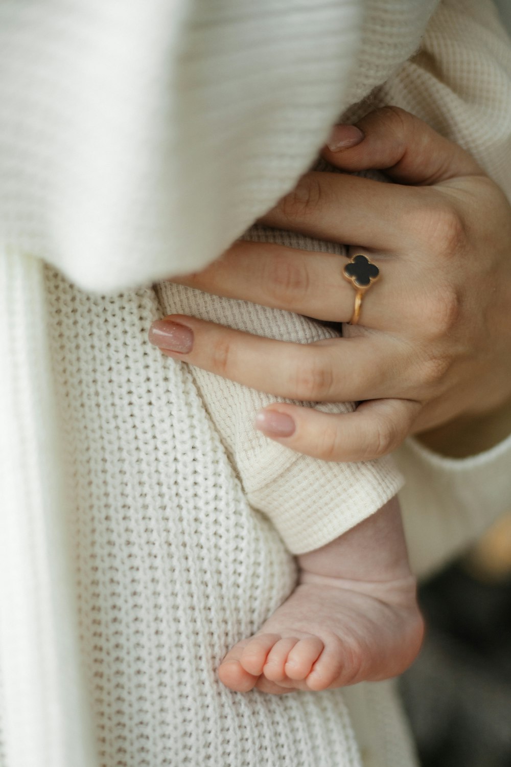 a close up of a person holding a baby