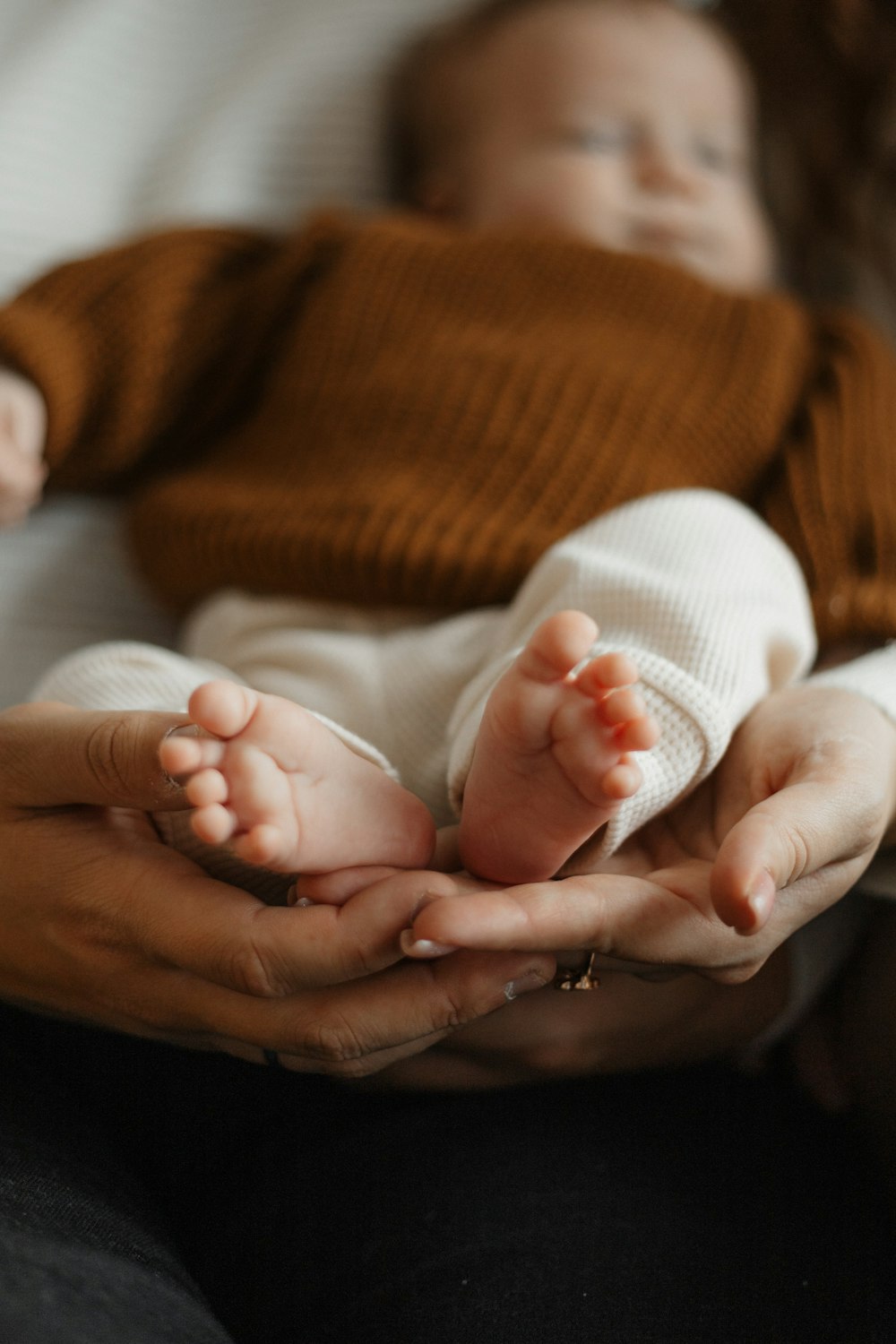 a woman holding a baby in her hands