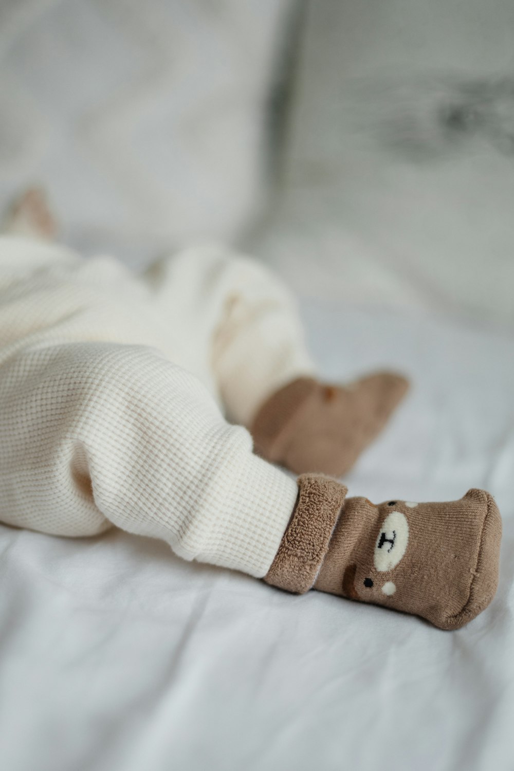 a baby laying on its back on a bed