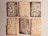 A set of six rectangular cookies arranged in two rows of three on a light background. The cookies have intricate floral patterns made of powdered sugar on their surfaces. There are two types, one with a darker brown color and another with a lighter golden-brown hue.