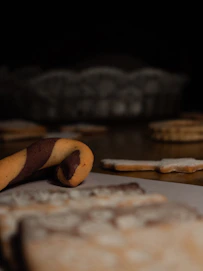 Close-up of beautifully decorated cookies in various shapes and colors, showcasing intricate designs.
