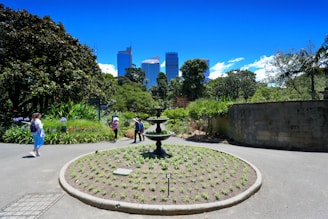 Residents enjoying a sunny afternoon in a beautifully landscaped garden space.
