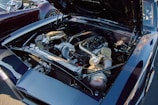 A high-performance car engine with exposed components such as large air intakes and shiny metallic parts. The engine bay is clean and well-organized, with a focus on showcasing the technical aspects of the engine.