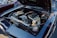 A high-performance car engine with exposed components such as large air intakes and shiny metallic parts. The engine bay is clean and well-organized, with a focus on showcasing the technical aspects of the engine.