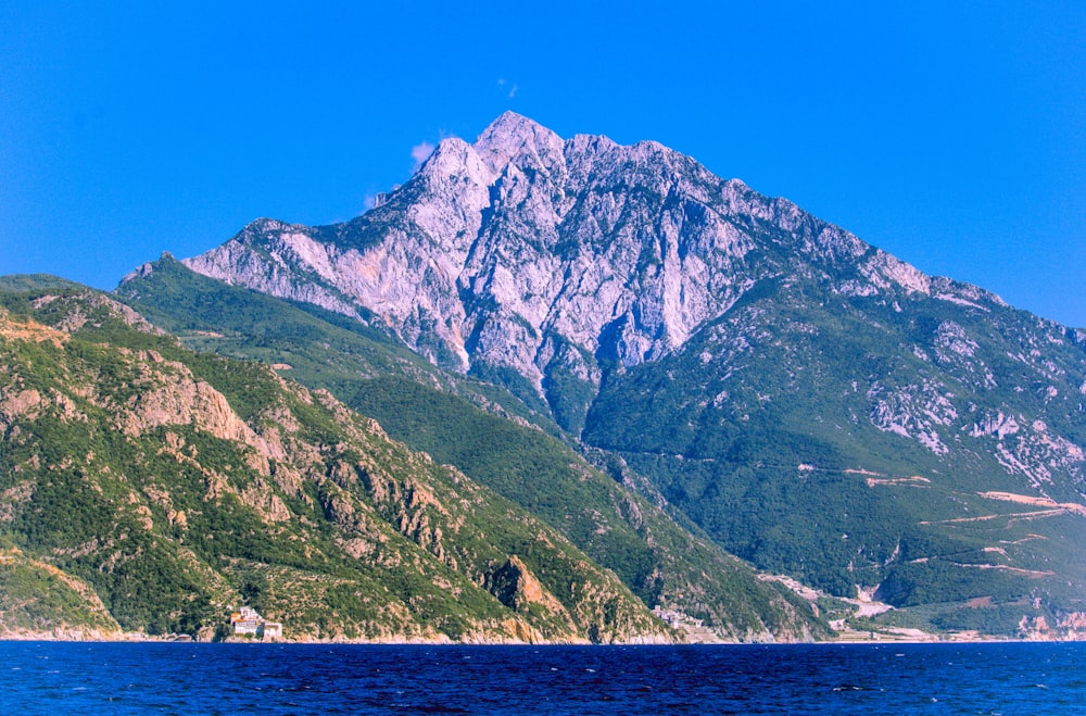 a mountain range with a boat in the water
