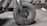 Close-up of a worker inspecting a stack of coated abrasive grinding wheels in a warehouse.