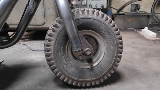 Close-up of a mechanic repairing a car tire in a workshop
