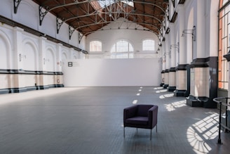 a purple chair sitting in a large room