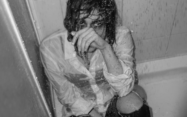 a person sitting in a bathtub covered in water