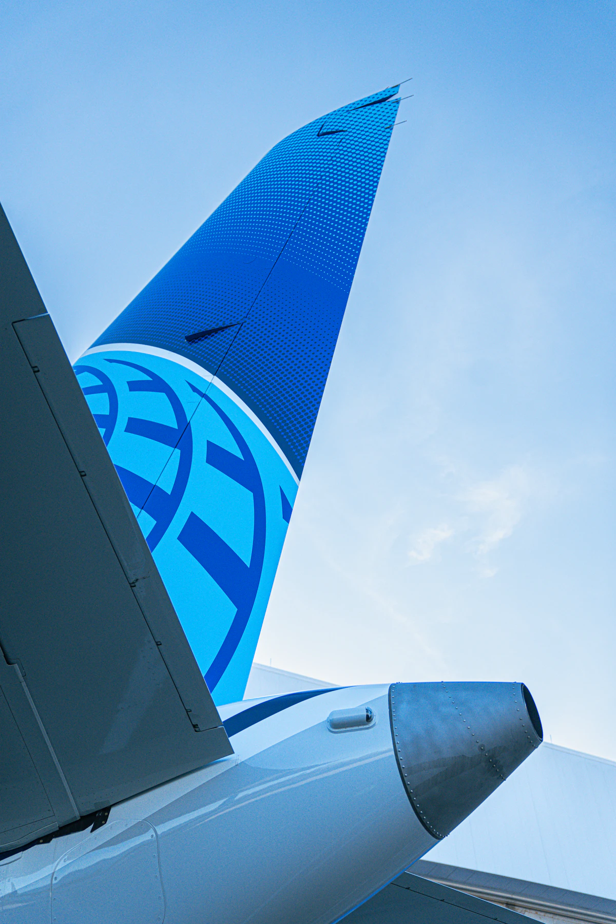 Tail of a commercial jet parked at an airport