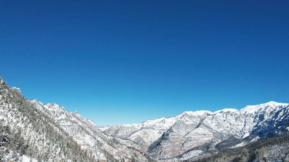 a view of a mountain range with snow on it