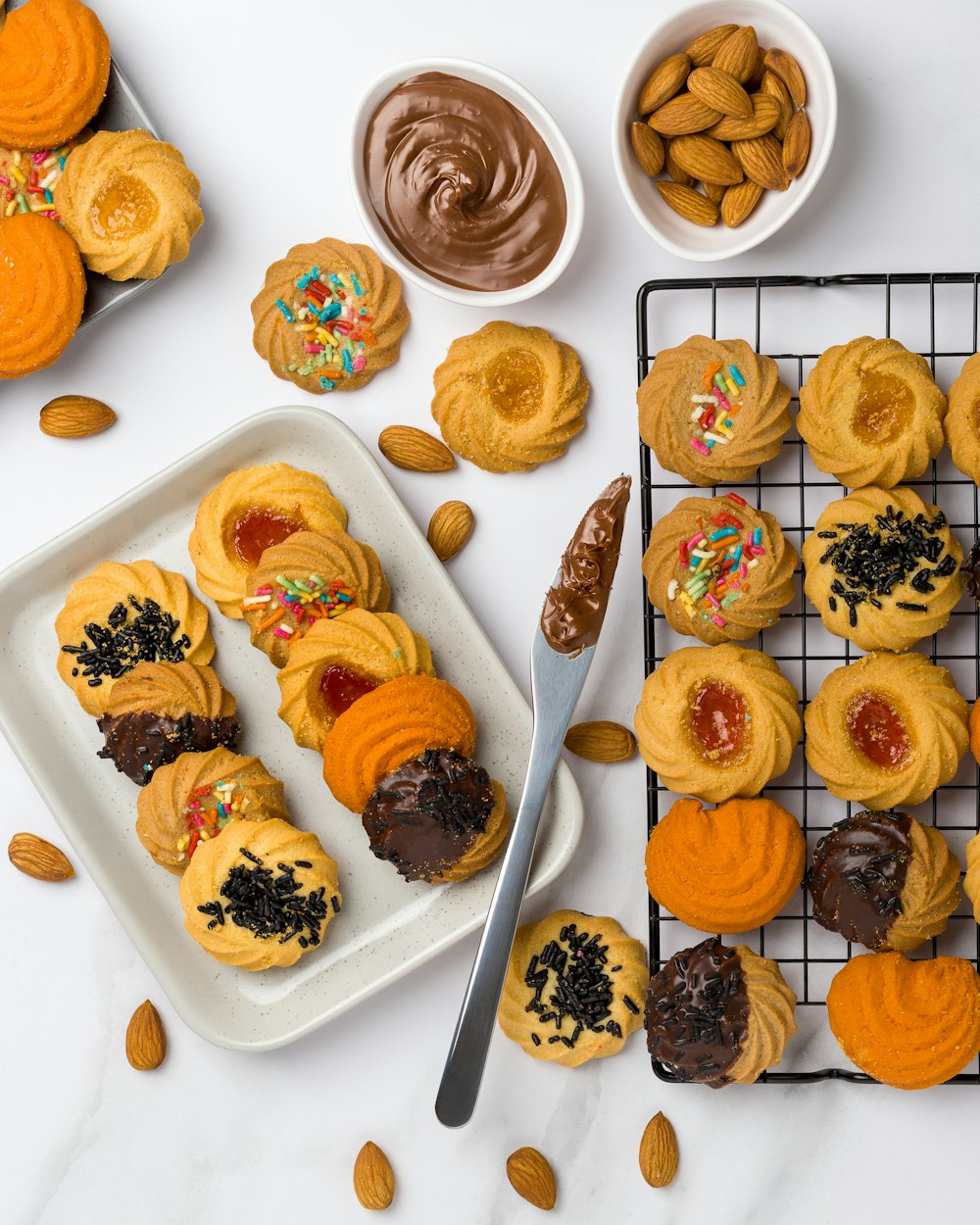 a table topped with cookies and other desserts