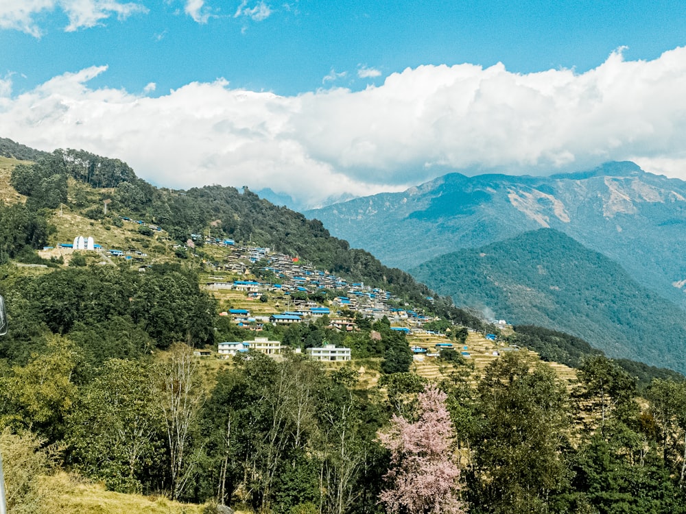 a scenic view of a mountain with houses on it