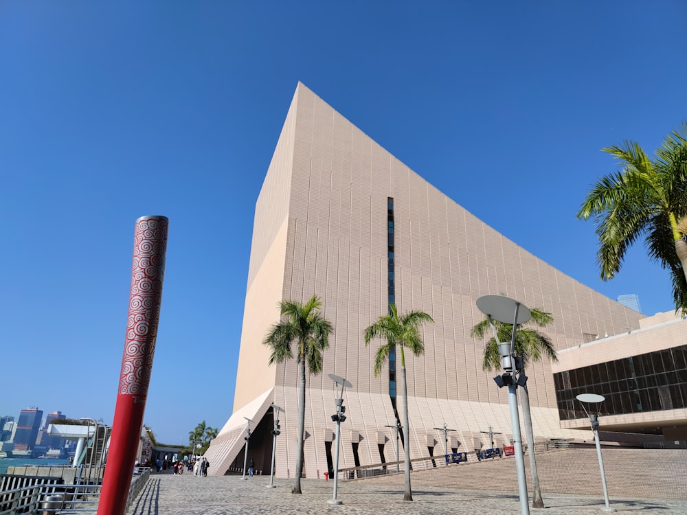 a tall building with palm trees in front of it