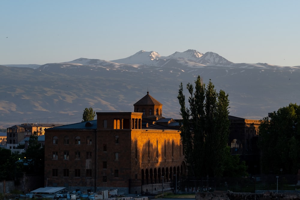 Una vista de una cadena montañosa con un edificio en primer plano