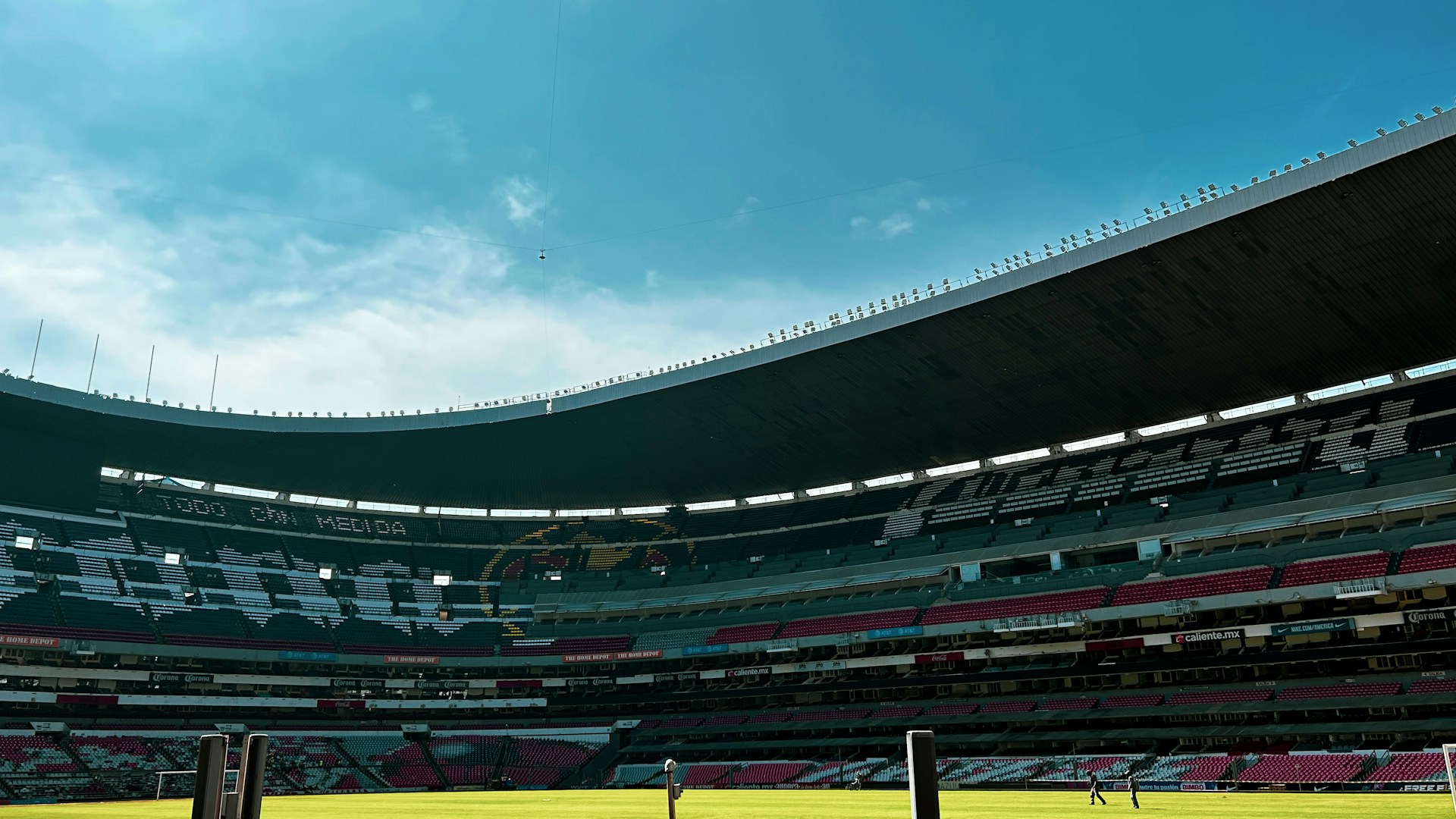 Aerial view of the stadium before renovation, showing the old seating and worn-out field under cloudy skies.