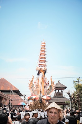 Brightly decorated carnival float moving through a cheering crowd.