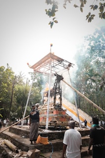 Family members watching respectfully as the cremation ceremony takes place at dusk.