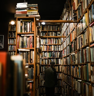 a person sitting in a room filled with lots of books
