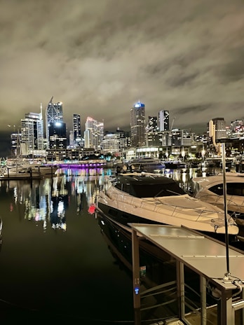 Night view of a yacht party with soft lighting reflecting on Dubai's skyline.