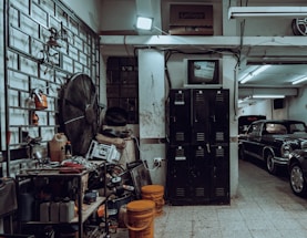 a garage filled with lots of junk and old cars