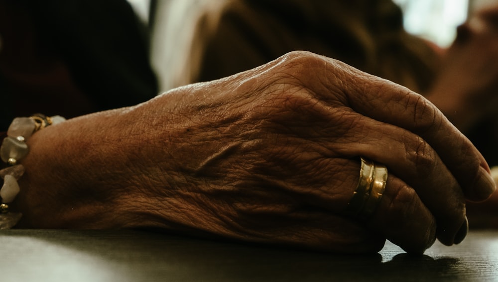 a close up of a person's hands resting on a table