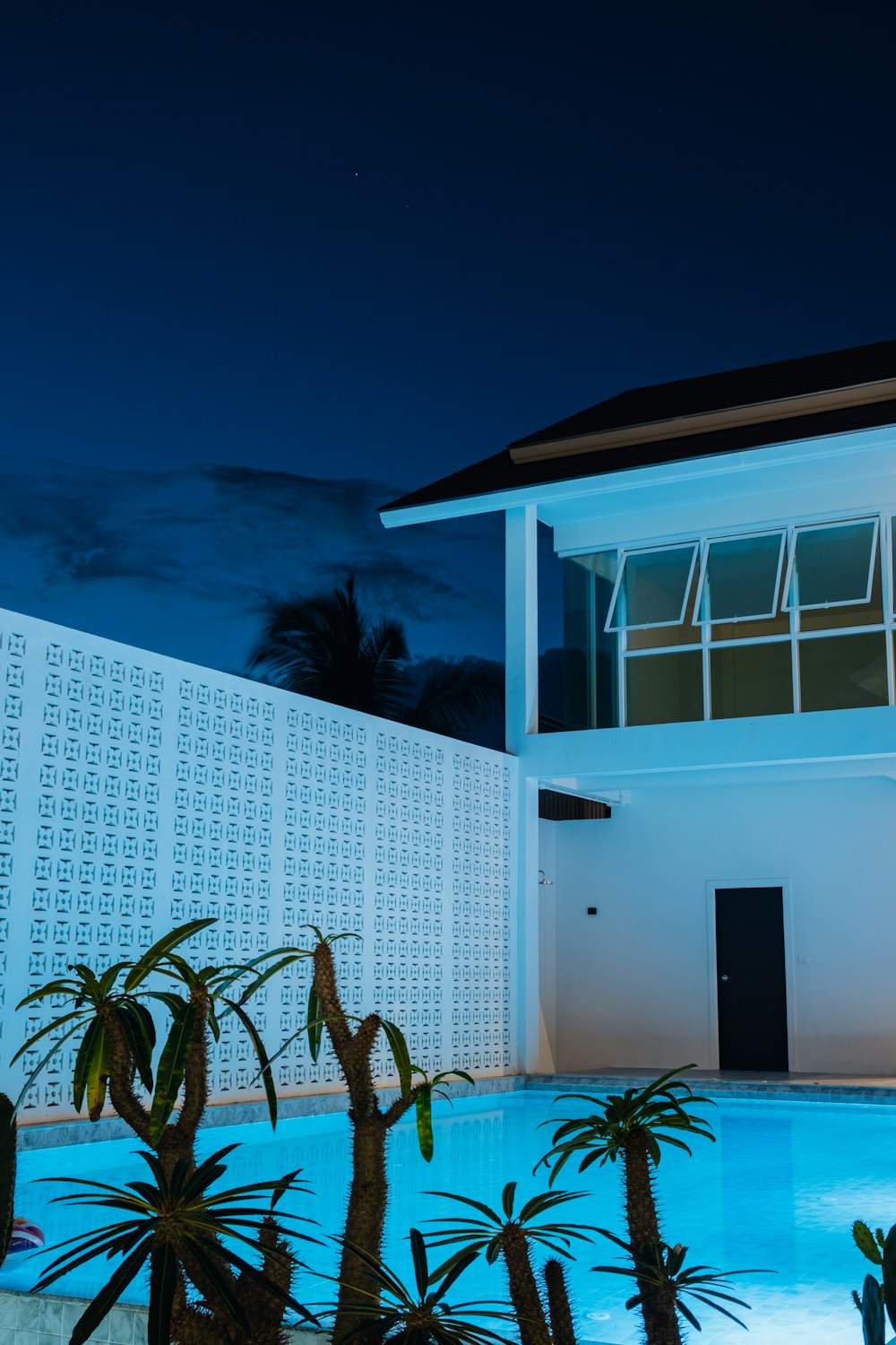 a house with a pool and a fence around it