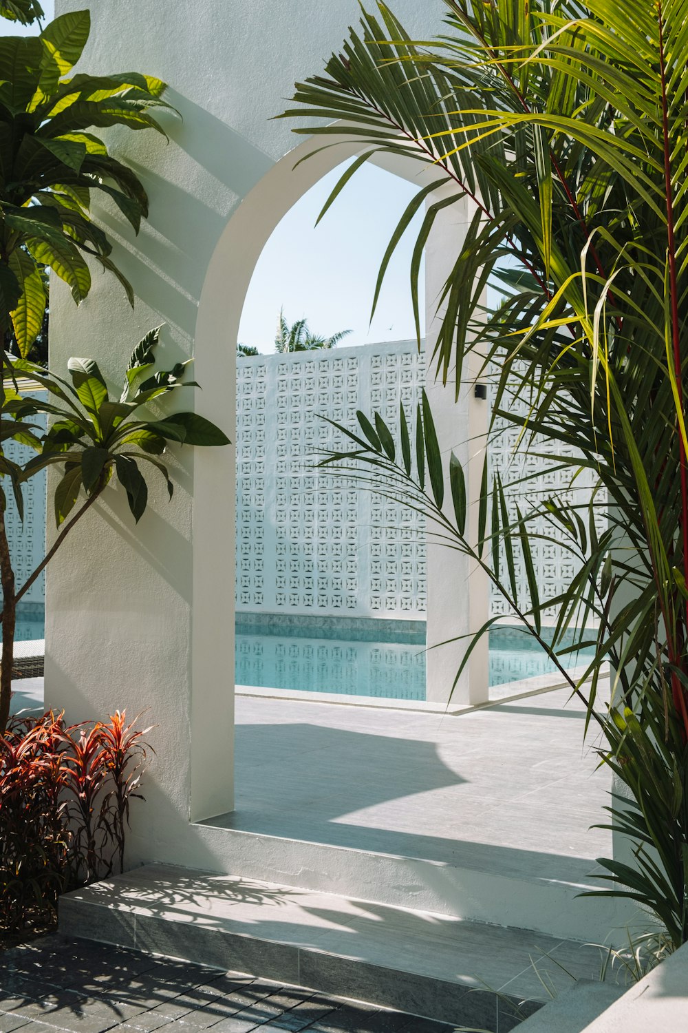 a white building with a pool in the middle of it