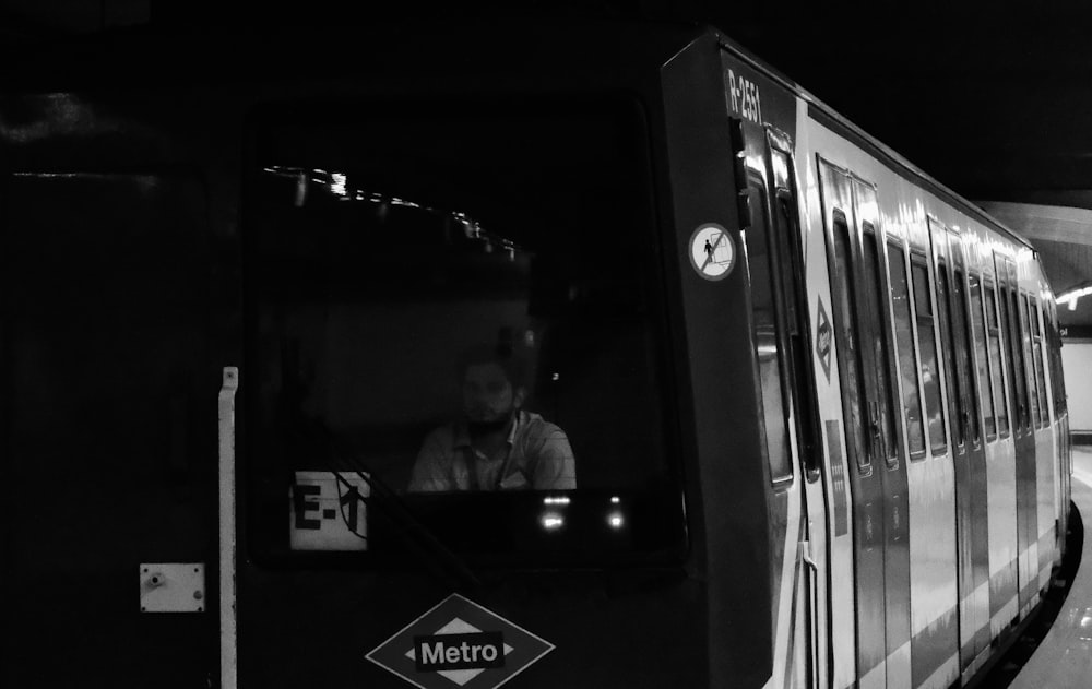 a black and white photo of a metro train