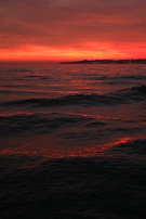 A vibrant sunset over the ocean with a reflective phrase about life and hope.