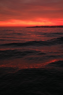 A vibrant California sunset reflecting on the ocean waves.