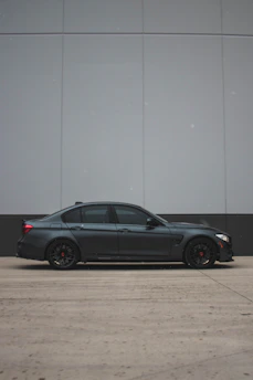 A clean, modern sedan parked outside a friendly neighborhood auto shop.
