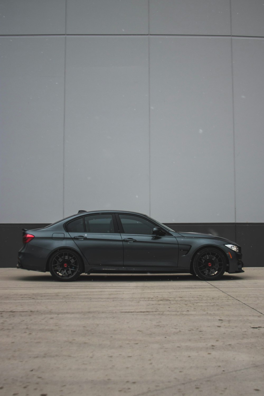 a black car parked in front of a building