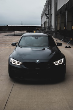 a black car parked in front of a building
