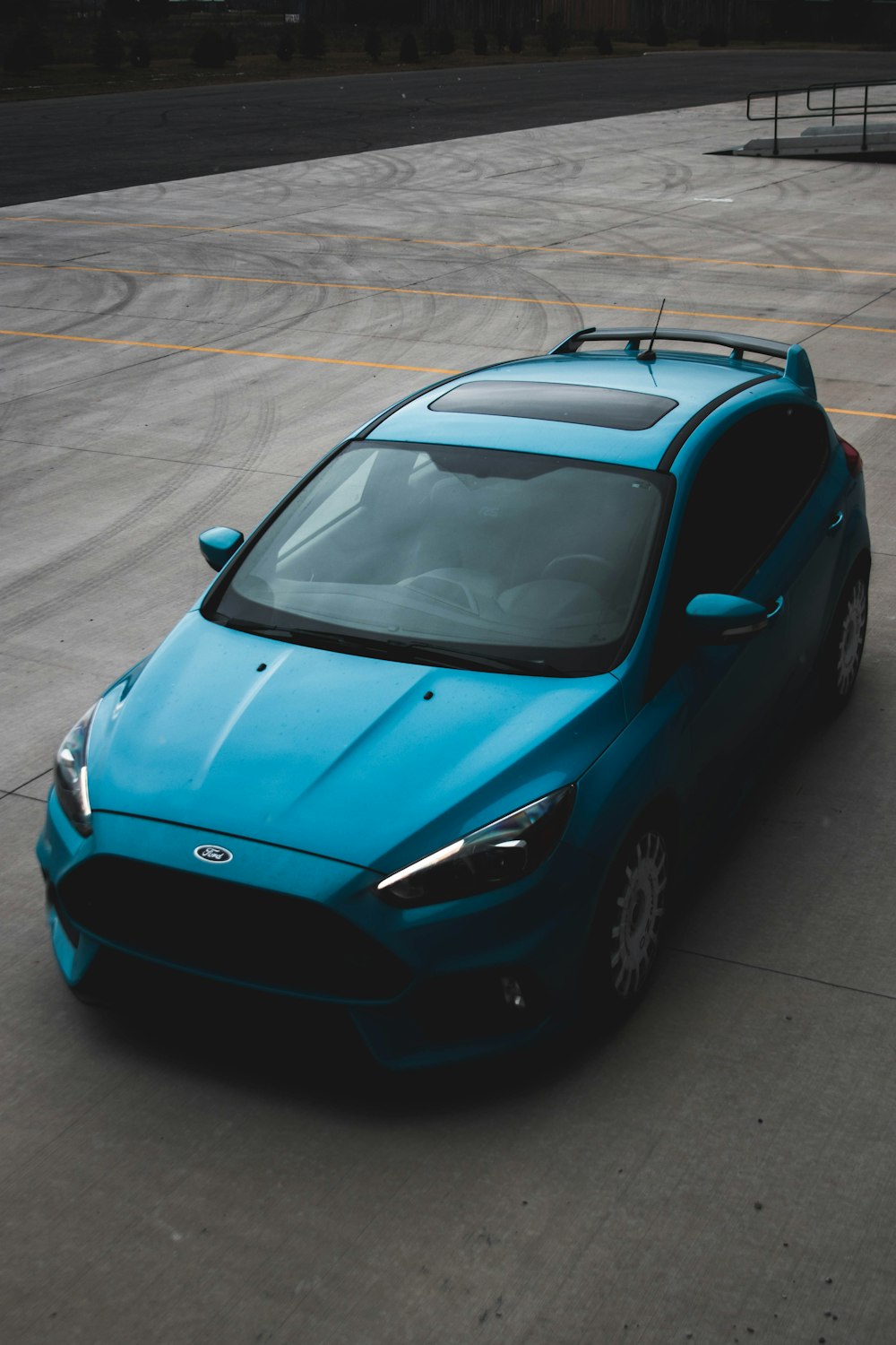 a blue sports car parked in a parking lot