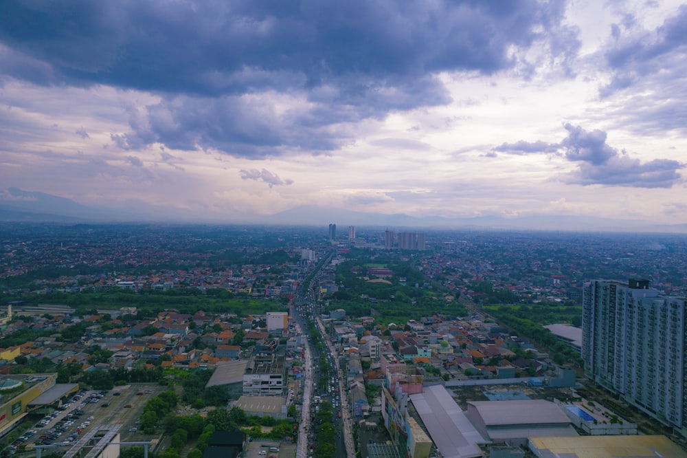 an aerial view of a city under a cloudy sky