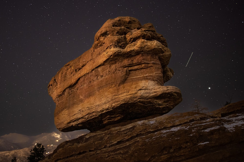 a rock formation with stars in the sky