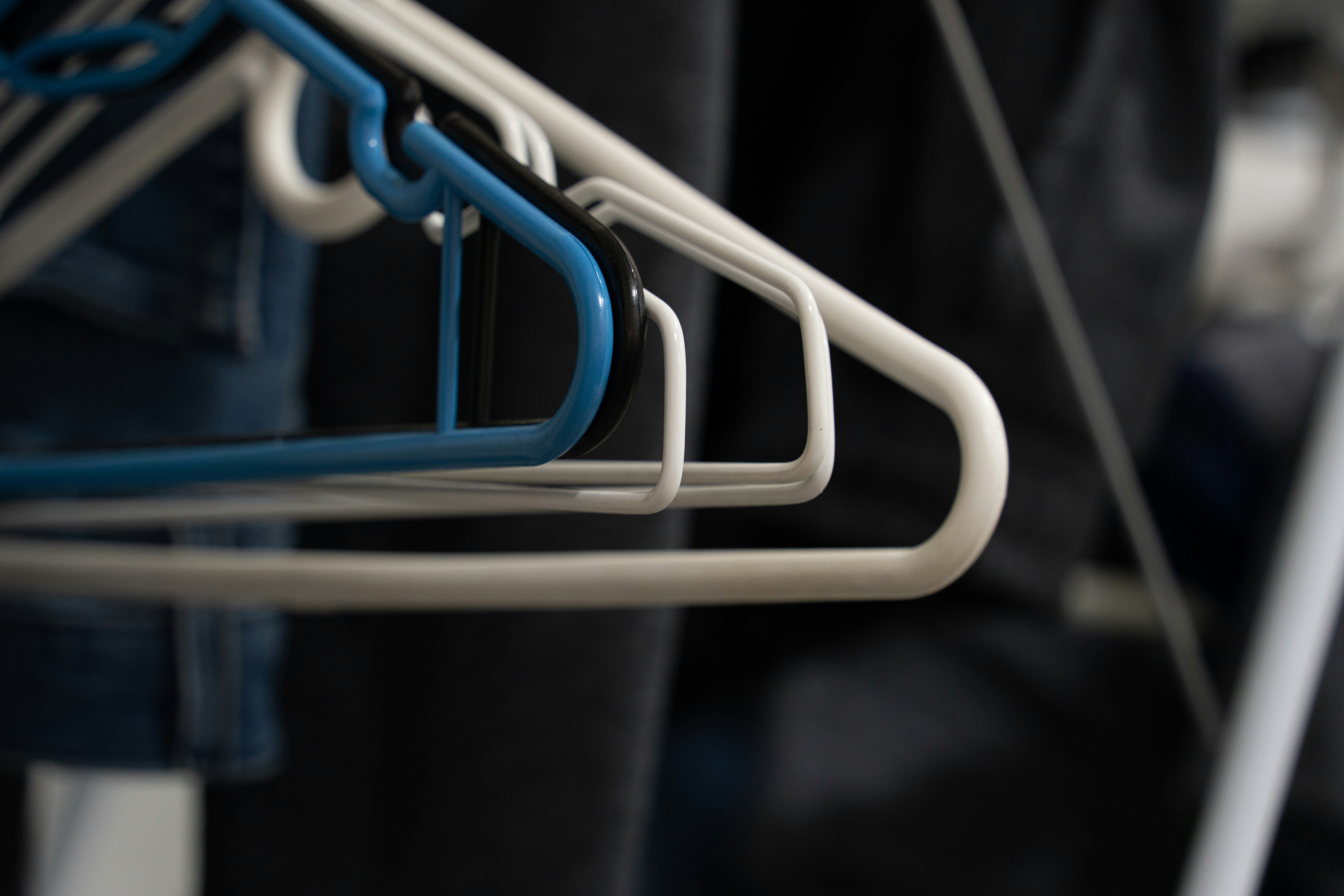 a row of blue and white clothes hangers