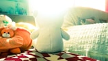 Delightful picture of a sleepy bear tucked in bed with a nightlight glowing softly.