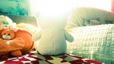 Delightful picture of a sleepy bear tucked in bed with a nightlight glowing softly.