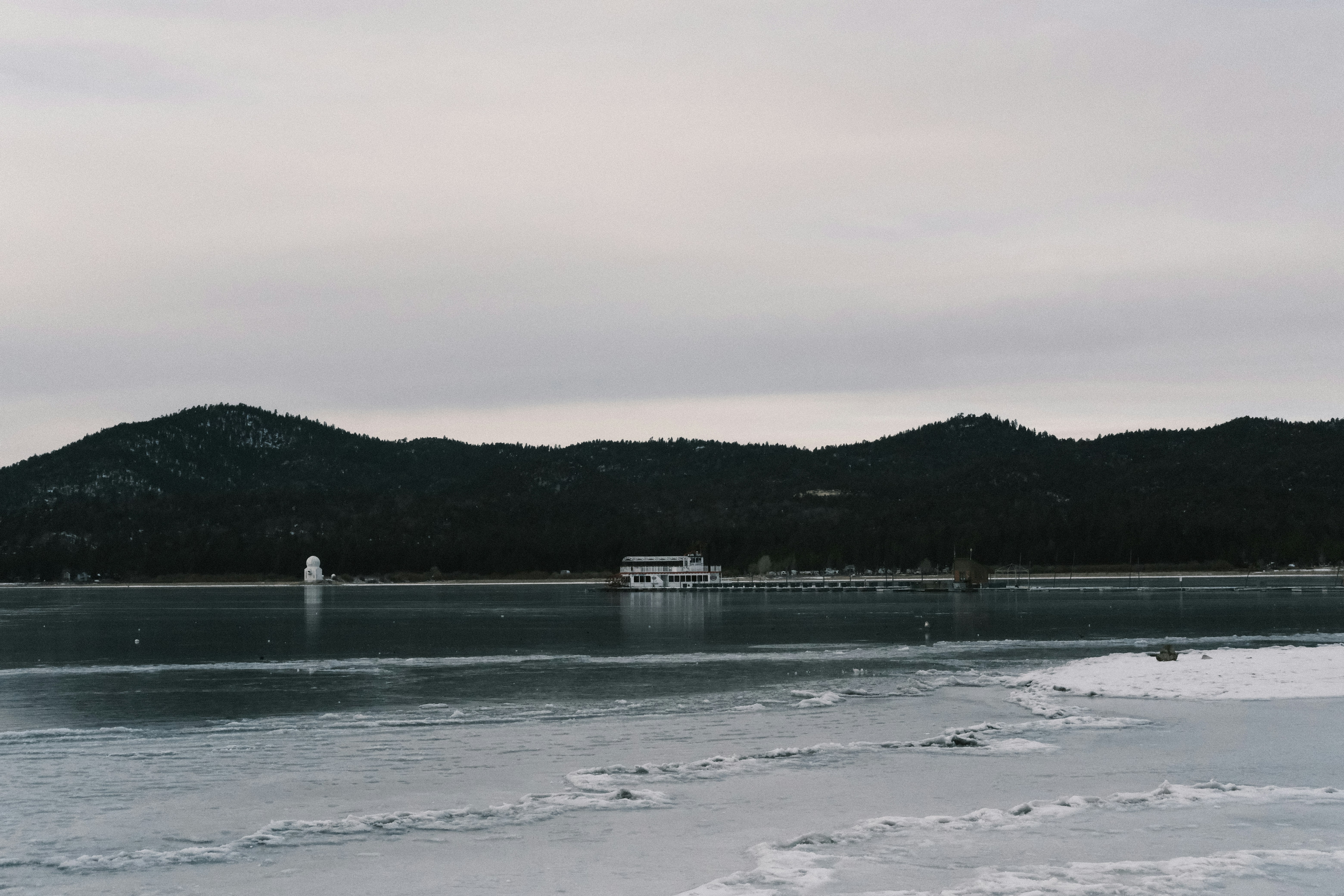 a large body of water with a boat in the distance